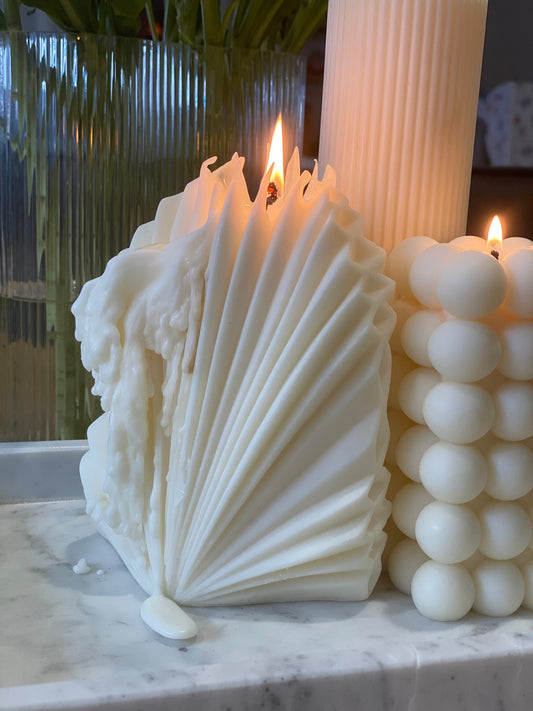 Decorative sculptural candle styled in a modern interior, designed to transform as the wax melts.