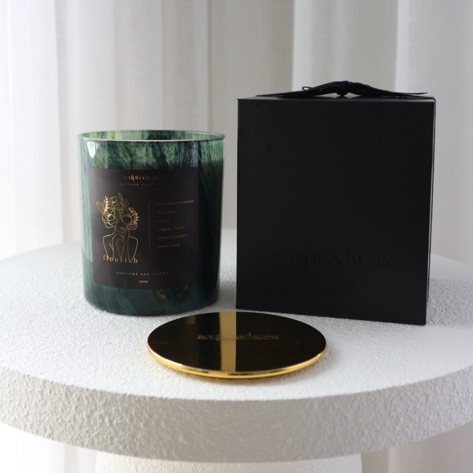 Flourish limited edition scented candle burning with warm glow, 55 to 70 hour burn time coconut soy candle