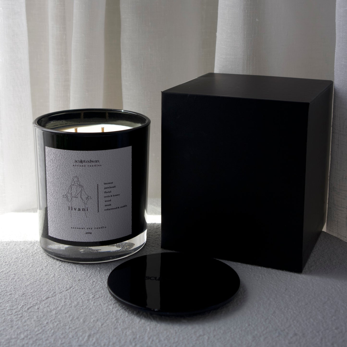 Livani limited edition scented candle burning with warm glow, 55 to 70 hour burn time coconut soy candle